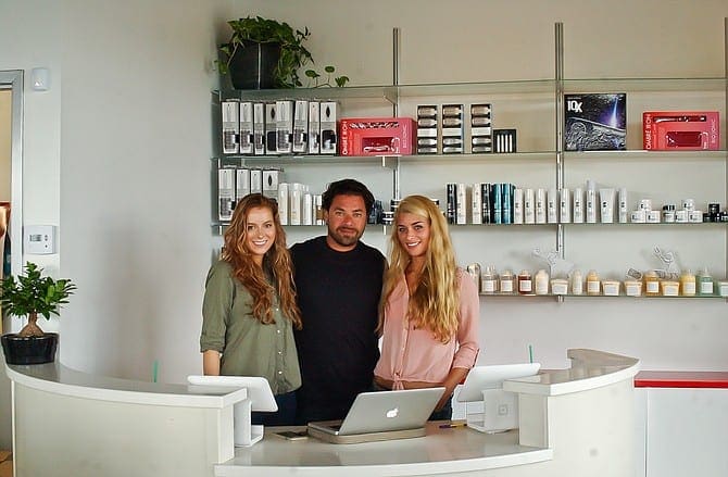Asad Alkurabi, along with Music to My Hair Salon manager Ashley Millet, left, and receptionist Michelle Vargason, right, prepare to open the new salon, which will offer a place for musicians and artists to show their work in addition to trying a different hairstyle