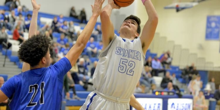 Shaker’s Matt Holmes (52) shoots over a Saratoga Springs defender during a Suburban Council game Friday, Feb. 5, in Latham.
Robert Goo/www.goosphotos.com