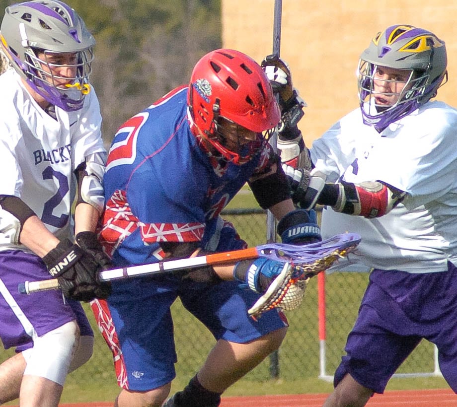 Voorheesville's Gabriel DeFreest-Rondeau, right, and Ian Owens, right, surround Maple Hill's Nick Morris during the first quarter of a Colonial Council game Wednesday, April 13. Rob Jonas/Spotlight