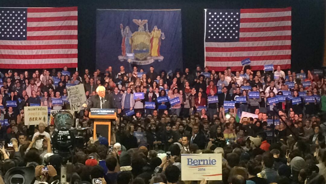 Sanders addresses thousands of enthusiastic supporters at Washington Armory in Albany.