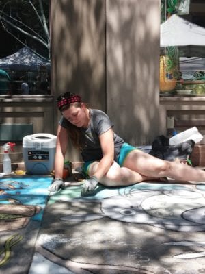 A sidewalk chalk artist works on her entry in the annual contest outside the Arts Center of the Capital Region during Troy River Fest on Saturday, June 18.