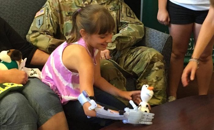 Karissa Mitchell, 9, picks up Olaf with the help of her new 3D printed arm created by a group of Siena College students. Mitchell received the arm Wednesday, June 22. Kassie Parisi/Spotlight