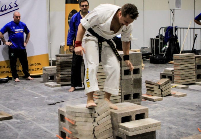 Colonie resident Adam Grogin breaks concrete blocks with his foot at the USBA and ISKA European Breaking Championships Saturday, July 2, in London, England. Submitted photo