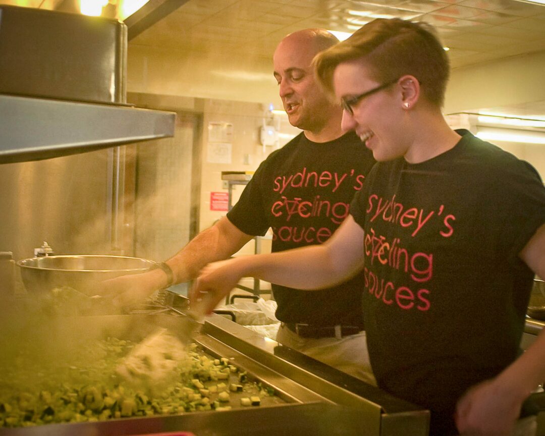 In this file photo from May 2015, Bethlehem High School Principal Scott Landry works with a student in the kitchen to prepare ingredients for a batch of Sydney’s Cycling Sauce. 
(Spotlight file photo)