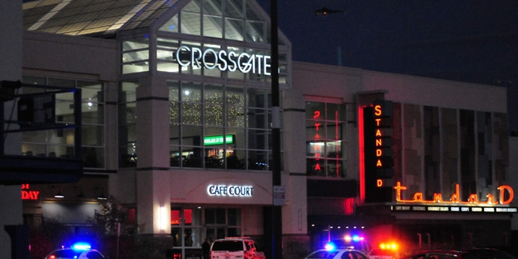 Multiple police agencies remained on the scene at Crossgates Mall at dusk Saturday evening as they continue their search for a suspect in an alleged shooting which took place inside the mall earlier in the afternoon.