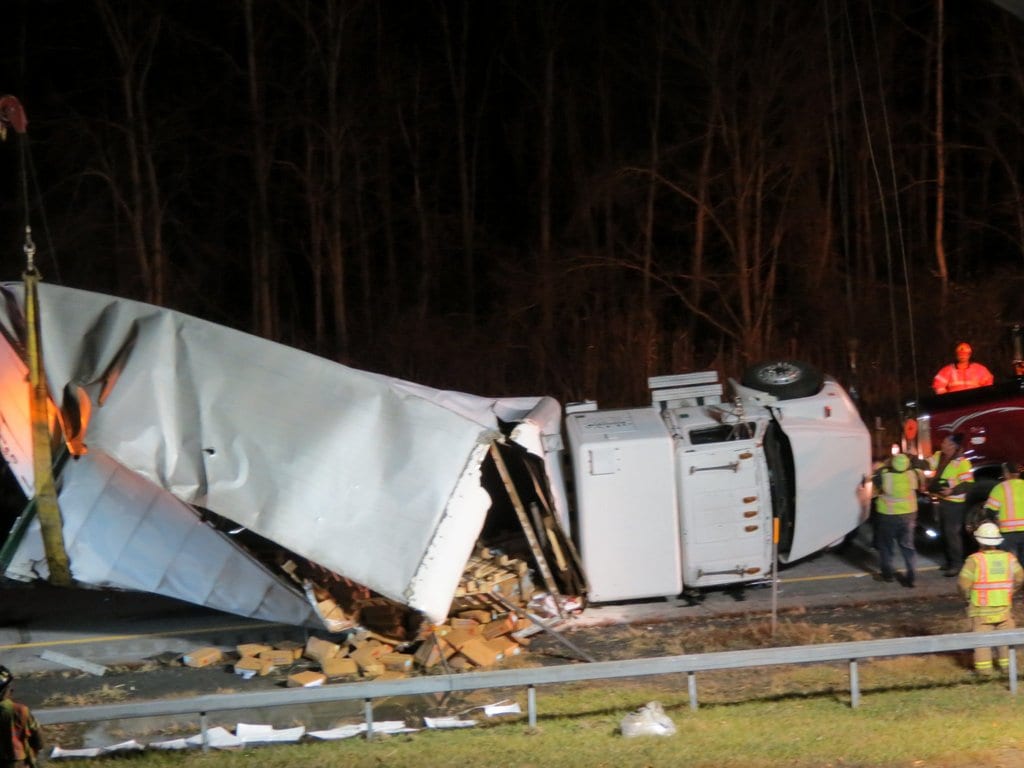 A large box truck spun around and flipped over near the Beaver Dam Road overpass on the New York state Thruway in Selkirk on Tuesday evening, Nov. 22. No injuries were reported. (Photo by Thomas Heffernan, Sr.)