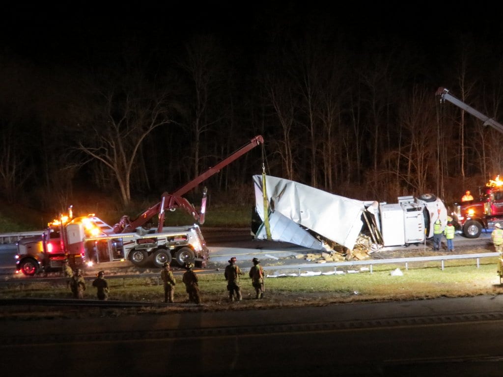A large box truck spun around and flipped over near the Beaver Dam Road overpass on the New York state Thruway in Selkirk on Tuesday evening, Nov. 22. No injuries were reported. (Photo by Thomas Heffernan, Sr.)