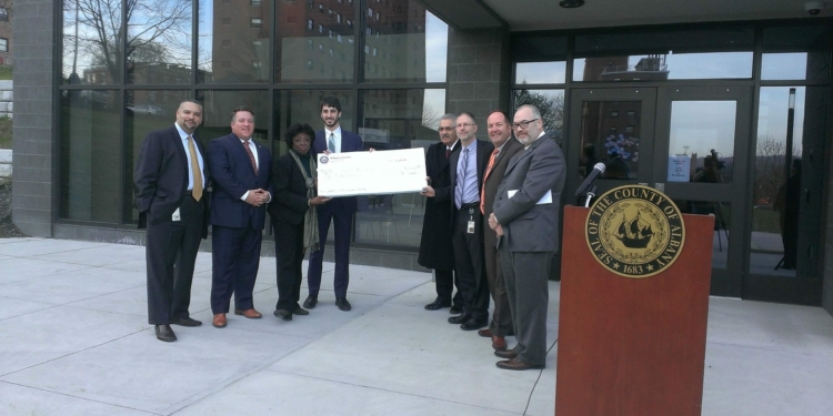 McKnight, Fein and Commisso hold the over-sized, overdue $50,000 check presented to Trinity Alliance officials at Dec. 10 press conference where McCoy announced that the funds had been "allocated." // Photo: County Executive, Facebook page