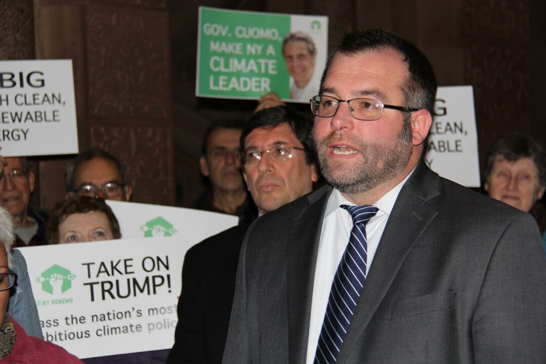 Conor Bambrick, air & energy director for Environmental Advocates of New York, joins with coalition on Friday, Dec. 16, to urge passage of climate protection legislation outside of the Senate Chamber on the third floor of the NYS Capitol. // Photo: EANY