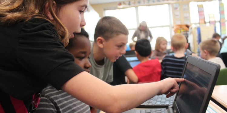 Slingerlands students in Mrs. Clarkson’s fourth grade class share computer programming fundamentals - and their Chromebooks - with first graders in Mrs. McCaffrey’s class during Hour of Code in early December // Photo: BCSD