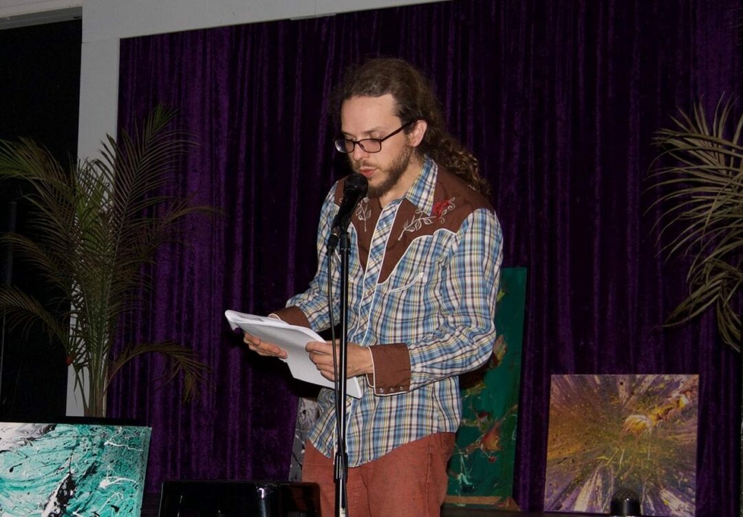 Chris Caulfield
reads from his poetry. Photo submitted)