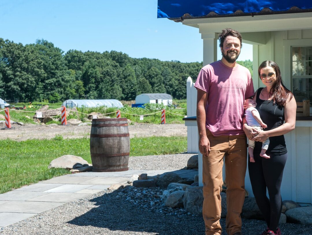 John Barker and Emma Hearst at the farm stand on their Forts Ferry Road Farm (Photo by Jim Franco)