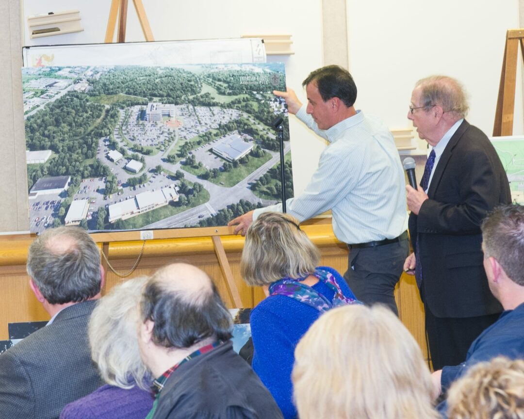Members of the Galesi Group present the sketch plan for Ayco's headquarters last year (Photo by Jim Franco/Spotlight News)