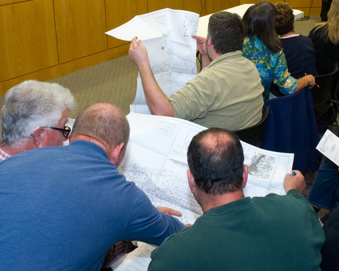 Residents look at the drawings for a housing development off of Troy-Schenectady Road. (Photo by Jim Franco/Spotlight News)