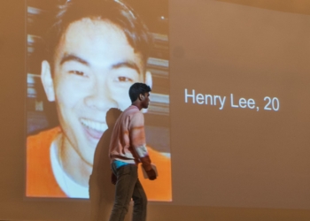 A Colonie student walks by a photo of Henry Lee, a student killed on the Virginia Tech campus in 2007, on the way to the podium to speak about school safety. (Photo by Jim Franco/Spotlight News)