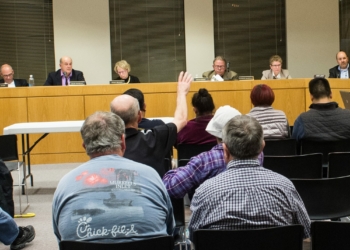 A resident raises his hand to speak at a recent Planning Board Meeting (Photo by Jim Franco/Spotlight News)