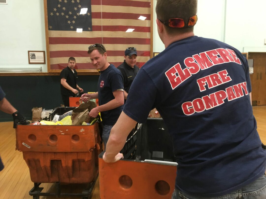 Town Board member and Elsmere volunteer Jim Foster helps to unload donations at Town Hall with fellow firefighters
                                                                                            Photo provided