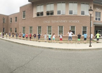 Students, faculty and staff at Eagle Elementary join hands as they surround their school, giving it a warm embrace on the final day of classes for the 2017-18 academic year, Wednesday, June 20. For the school’s fifth graders, it was the last time they’ll participate in this annual tradition, as they’ll attend Bethlehem Central Middle School  in the fall. 
Photo courtesy Bethlehem Central School District.