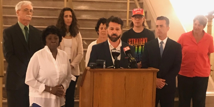 Backed by advocates and fellow legislators, Bryan Clenahan speaks in advance of the vote on the “conversion therapy” ban.
Photo by Amanda Savarese, Albany County