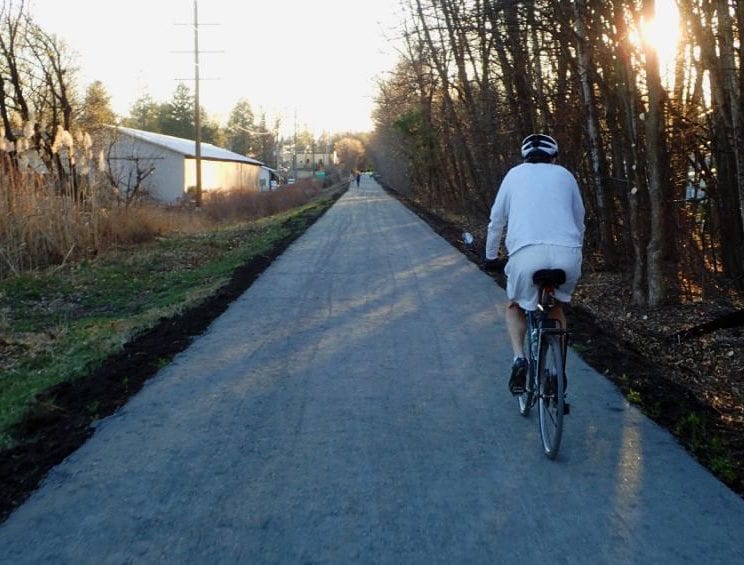 A bicyclist on the Albany County Helderberg Hudson Rail Trail approches Delmar’s Warehouse District on an autumn day. Local businesses are seeing more people visit them by means of the Rail Trail, and could see more in the coming weeks.

Spotlight file photo