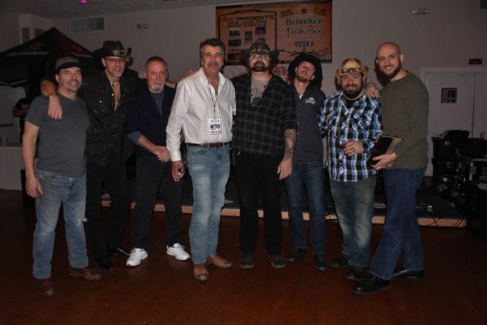 True Grit Outlaws, with their sound man, Matt (far right) and 88.3 The Saint Radio Personality, Vito Ciccarelli, at Parti Events & Banquet Hall, Troy, NY 1/10/19. Photo Credit: Amy Modesti