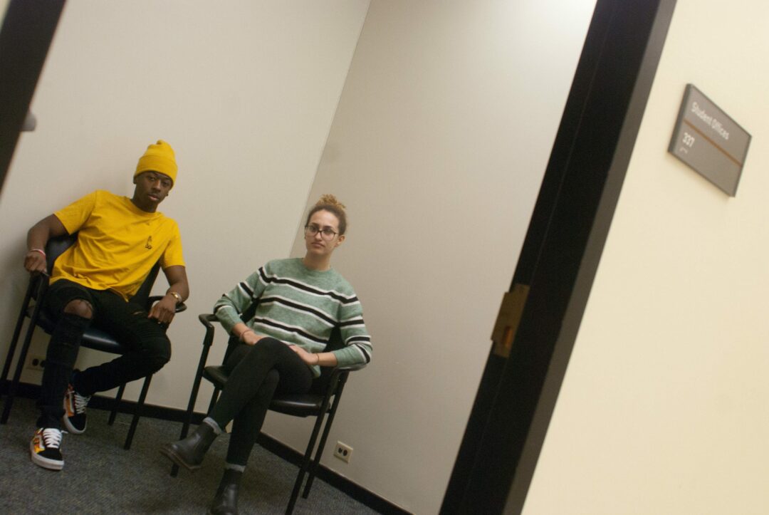 UAlbany’s Photo Services vice president Jarron Childs, left, and president Sabrina Flores, right, sit in the much smaller room the university offered for the club to move into. Both noted that the room could not fit half of their original studio’s equipment and they would lose their darkroom. Diego Cagara / Spotlight News