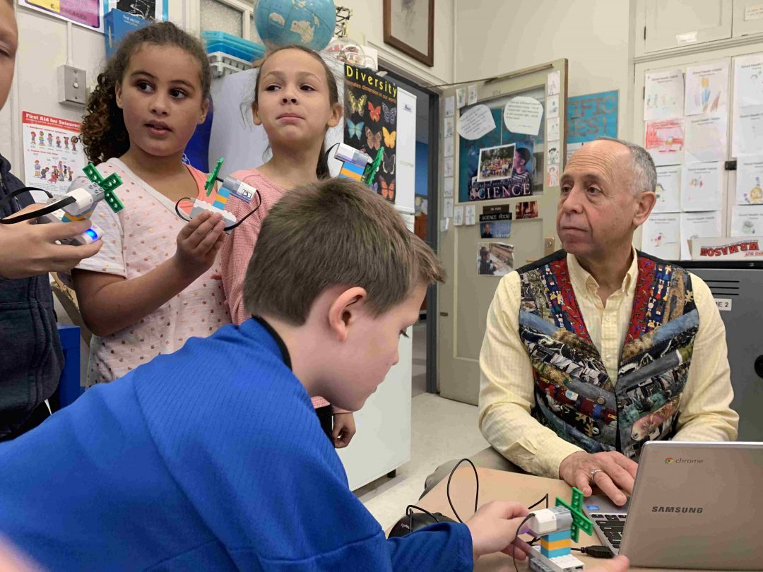 Dr. Alan Fiero, right, tasked his second graders to build a cooling fan from LEGO pieces, connect them wirelessly to their Chromebooks, and program them to perform tasks.
Diego Cagara / Spotlight News