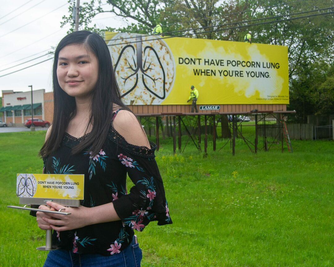 Michelle Tran stands in front of her billboard on Route 155 on Friday, May 17.
Jim Franco/Spotlight News