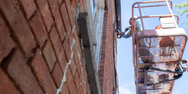 Ken Granger, of VMJR Companies, points up brick on the outside of the Pruyn House.
Jim Franco/Spotlight News
