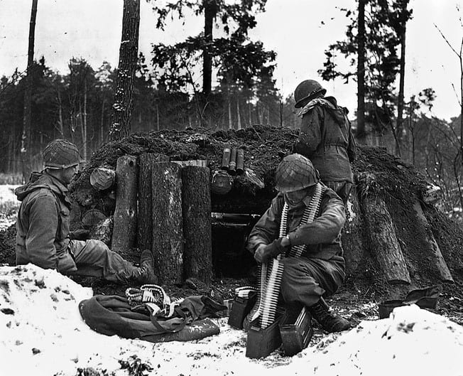 U.S. Army Soldiers of the 42nd Infantry Division’s Task Force Linden prepare a defensive position at their log and dirt bunker near Kauffenheim, France, Jan. 8, 1945.2. (U.S. Army Photo)