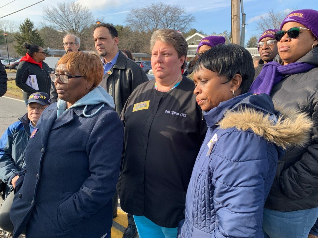 Concerned employees stand outside for a press conference on Tuesday, Jan. 14. Mindy Berman