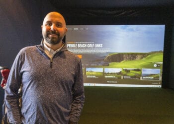 Normanside Country Club Managing Director Dave Hostig stands before one of his five golf simulators now at the country club. It allows golfers a change to keep their swing fresh while playing a virtual round at various real world and fictitious courses.	

Michael Hallisey / Spotlight News