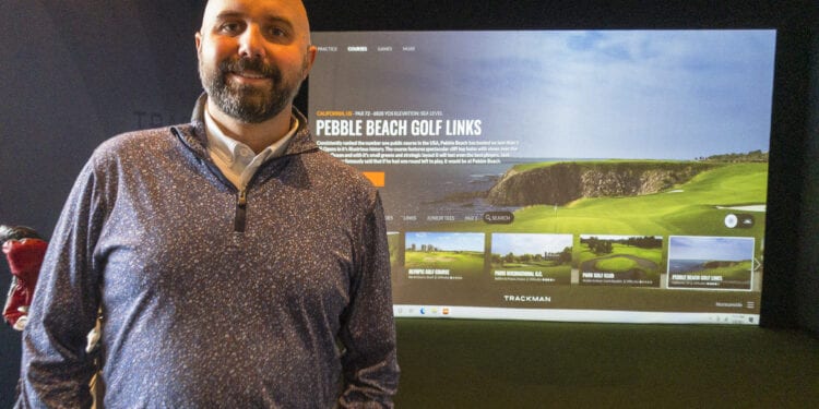 Normanside Country Club Managing Director Dave Hostig stands before one of his five golf simulators now at the country club. It allows golfers a change to keep their swing fresh while playing a virtual round at various real world and fictitious courses.	

Michael Hallisey / Spotlight News
