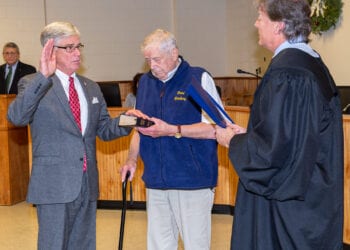 Fred Field holds the Bible as his son, Rick Field, is administered the Oath of Office to serve on the Colonie Town Board by Judge Peter Crummey in January, 2020. (Jim Franco / Spotlight News)