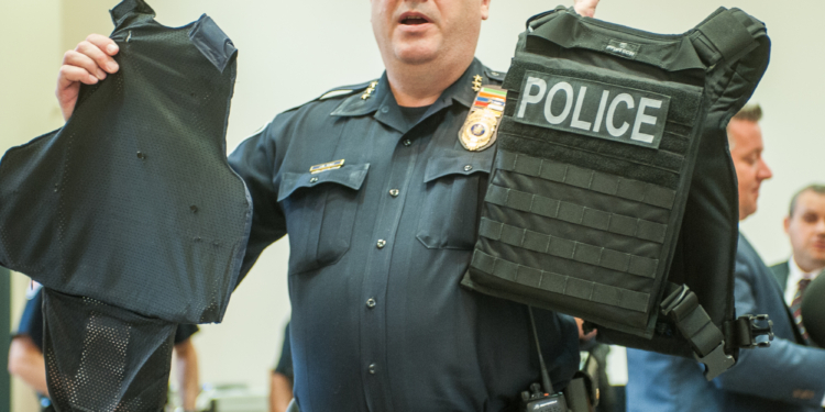 Colonie police chief Jonathan Teale holds up a piece of body armor in 2017 (Jim Franco/Spotlight.com)