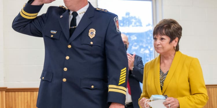 Colonie Police Chief Mike Woods salutes a room full of police officers after being sworn in by Supervisor Paula Mahan (Jim Franco /Spotlight News)