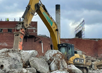 Jackson Demolition reduces large chucks of concrete to rubble while the Tobin's smokestack looms in the background. (Photo submitted)