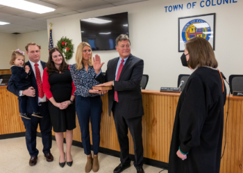 Colonie Town Supervisor Peter Crummey, who was elected last year, is sworn in by U.S. Judge Mae D’Agostino while Sandy Oakley holds the Bible. His daughter, Carol Crummey McCardle, along with her husband, Jon McCardle, and their daughter, Elizabeth, were also present on Saturday, Jan. 1, 2022 at Town Hall. (Jim Franco/Special to the times Union)