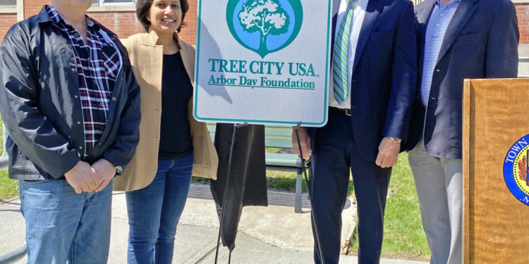 (From left) Timothy Barnard, a member of the town Conservation Advisory Council, CAC Chairwoman Zainab Magdon-Ismail, Supervisor Peter Crummey and Town Board member Jeff Madden hold a Tree City USA sign. 
Photo submitted