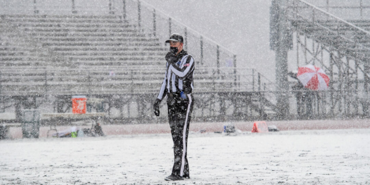 A football referee tries to stay warm durig a pop up snow storm during a game between CBA and Shenendehowa in 2021.
Jim Franco / Spotlight News