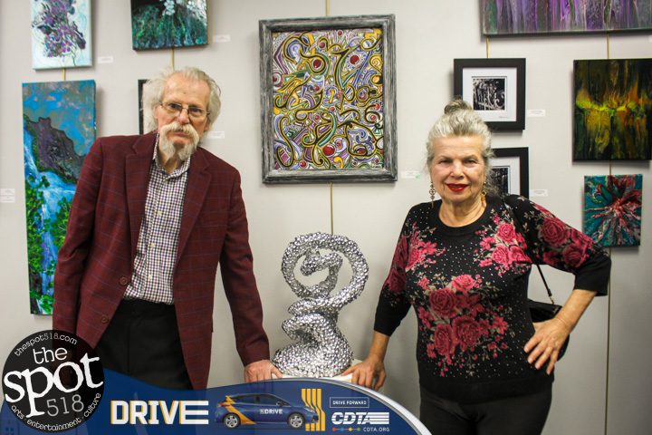 Art Associates Gallery Inc. owners Attila and Kinga Zalavary posing near artwork made by members of the United Artist Guild, Friday, May 5.