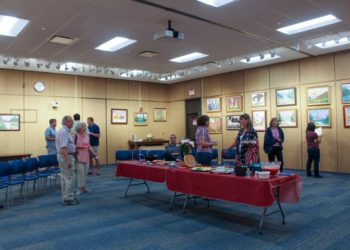 People attending the opening of "A Contemplative Life:1926-2021 - The Paintings of Joseph Nicpon" on view at The William K. Sanford Town Library, Saturday, July 1,2023