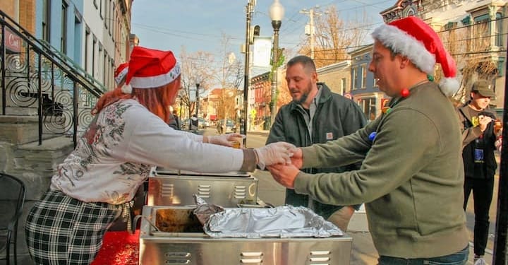 Event goers picking up some chili and chowder from Savoy Taproom on Lark Street in Albany, NY, Saturday, Dec. 9, 2023.